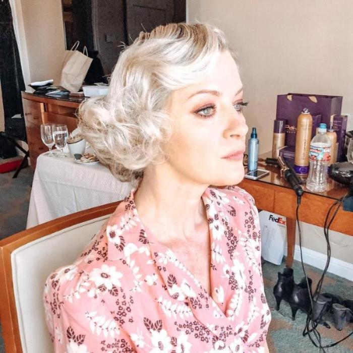 Gretchen in dressing room, wearing pink floral print dress
